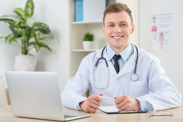 Australian-registered clinician reviewing a patient referral on a laptop
