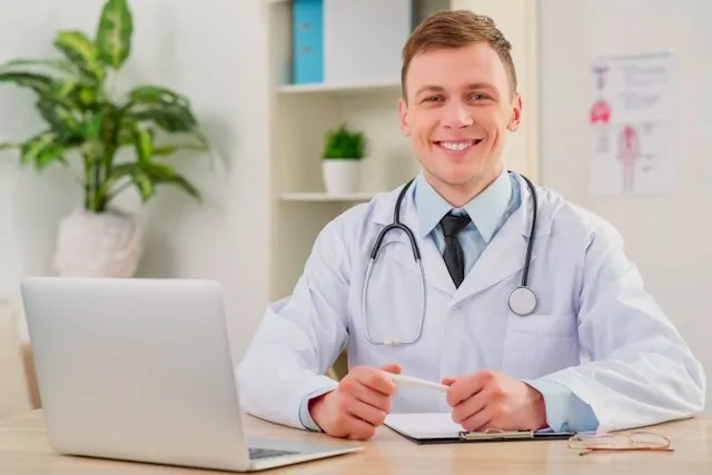 Australian-registered clinician reviewing a patient referral on a laptop